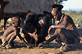 Trois hommes de l'ethnie Himba allumant un feu